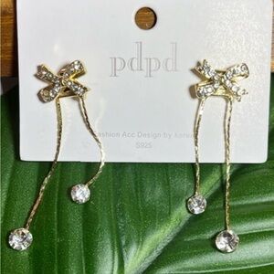 Fashion jewelry pierced drop earrings, rhinestones gold tone plated background